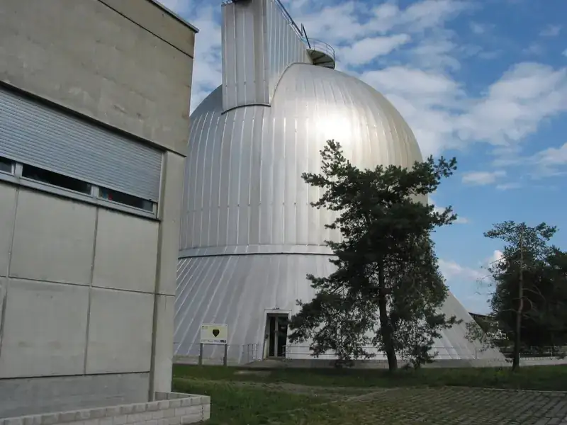 White domed digesters at the Ravensburg plant against a blue sky.